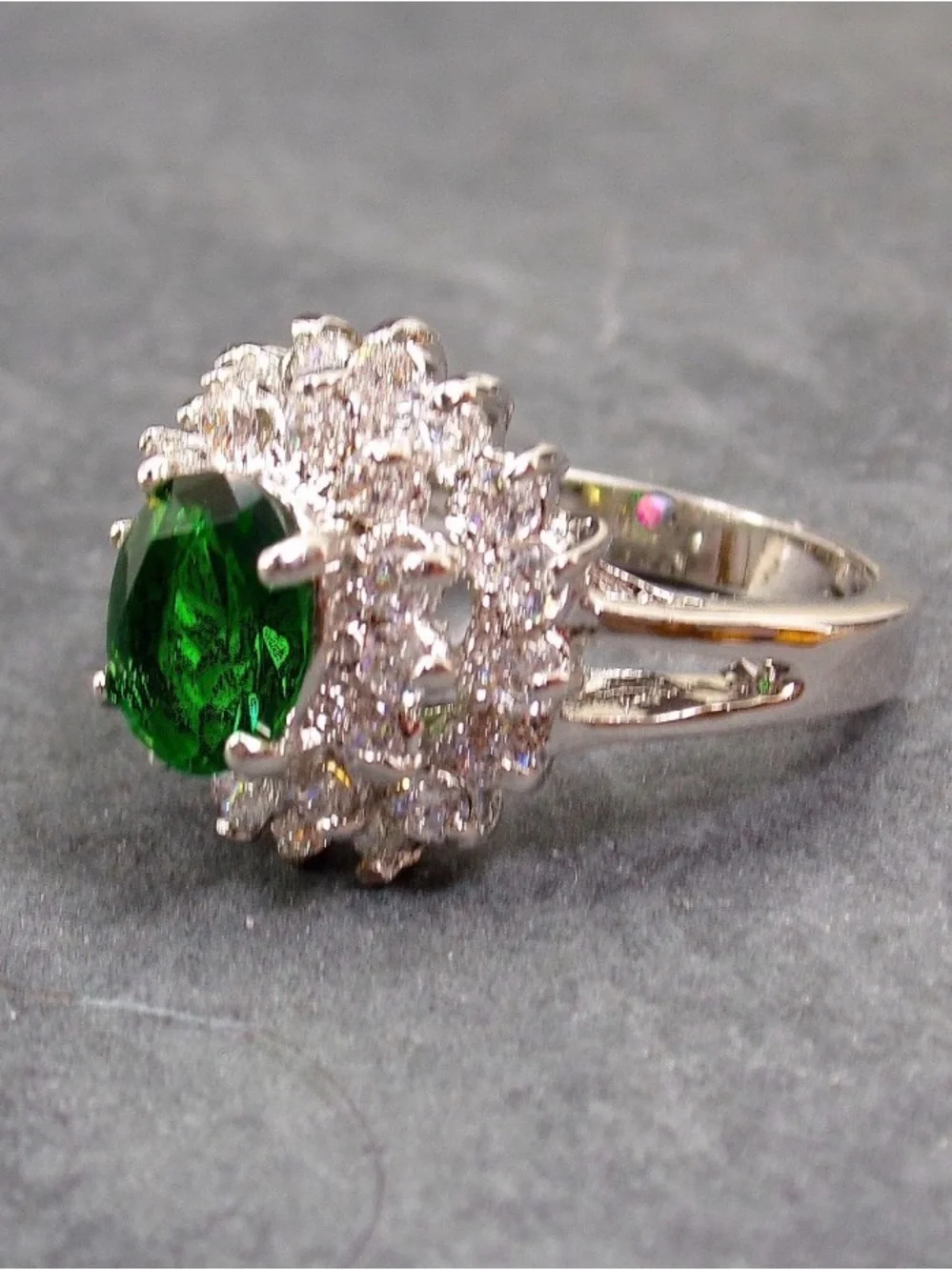 Green oval cubic zirconia stone ring w/ clear stones in a raised setting SZ 6.5